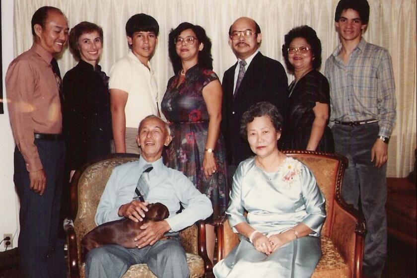 Lloyd Dong Sr. and his wife Margaret Dong sit in a family photo taken in their Coronado home in the 1980s.