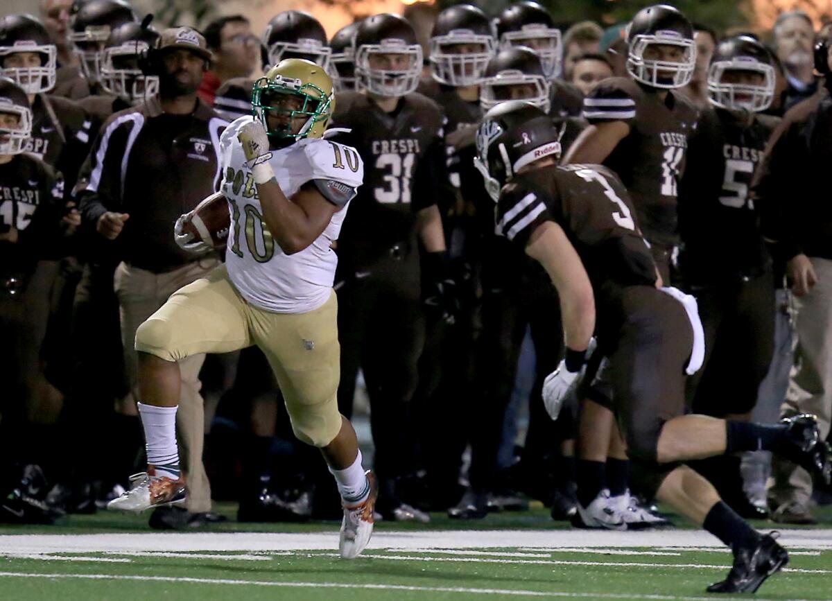 Long Beach Poly running back James Brooks breaks for a long touchdown run against Crespi in the third quarter of a Pac-5 quarterfinal game on Nov 21.