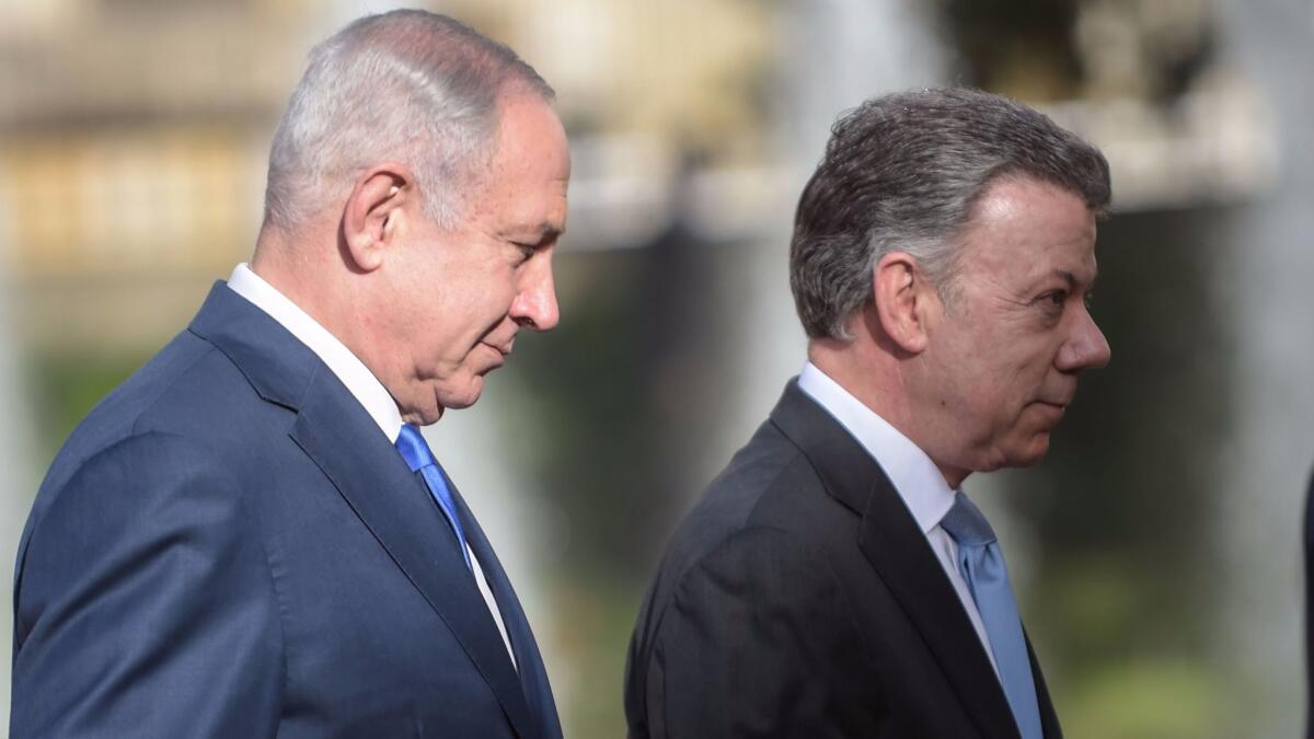 Israeli Prime Minister Benjamin Netanyahu, left, and Colombian President Juan Manuel Santos attend a ceremony to welcome the Israeli leader at the Nariño palace in Bogota on Sept. 13, 2017.