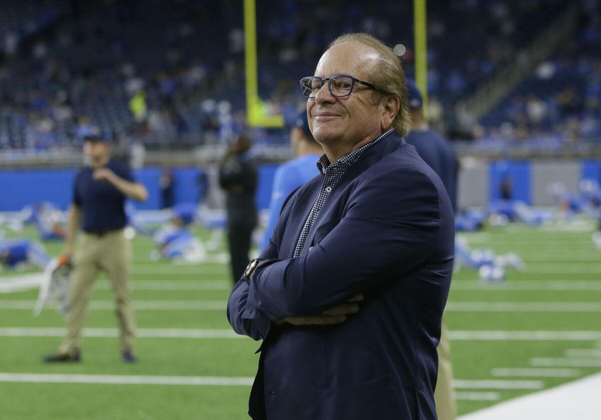 Chargers owner Dean Spanos watches the team warm up before a game against the Detroit Lions.