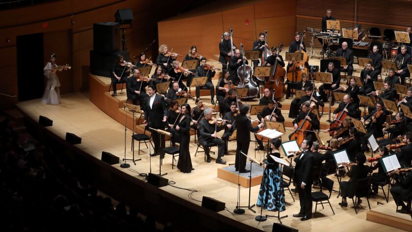 Dancer Chen Yining (far left) with conductor Gustavo Dudamel, the Los Angeles Philharmonic and vocal soloists in the U.S. premiere of Tan Dun's 'Buddha Passion' at Walt Disney Concert Hall on Friday night,