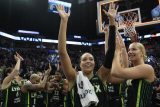 Minnesota Lynx forward Napheesa Collier, center, celebrates with teammates after the 88-77 win against the Connecticut Sun of Game 5 of a WNBA basketball semifinals, Tuesday, Oct. 8, 2024, in Minneapolis. (AP Photo/Abbie Parr)