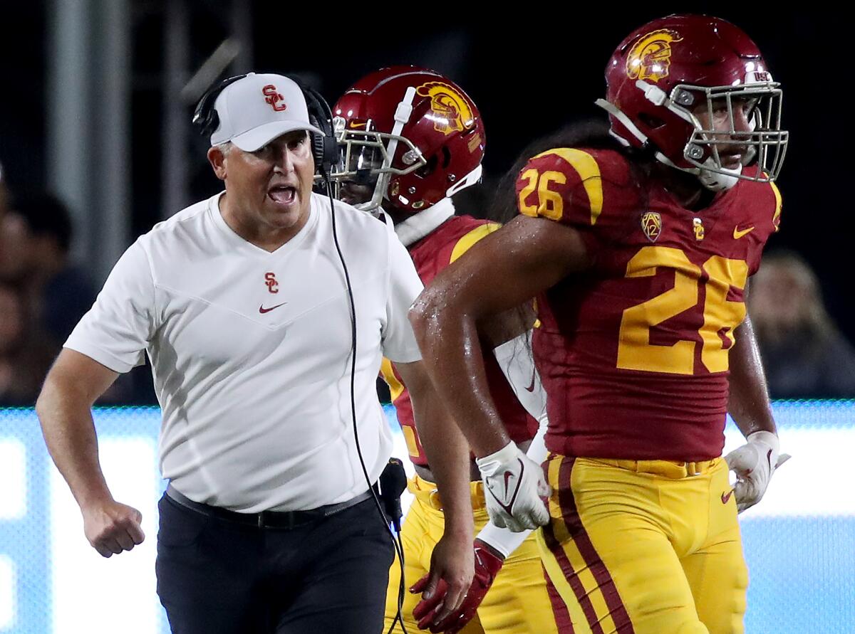 USC coach Clay Helton walks on the sideline during Saturday's loss to Stanford.