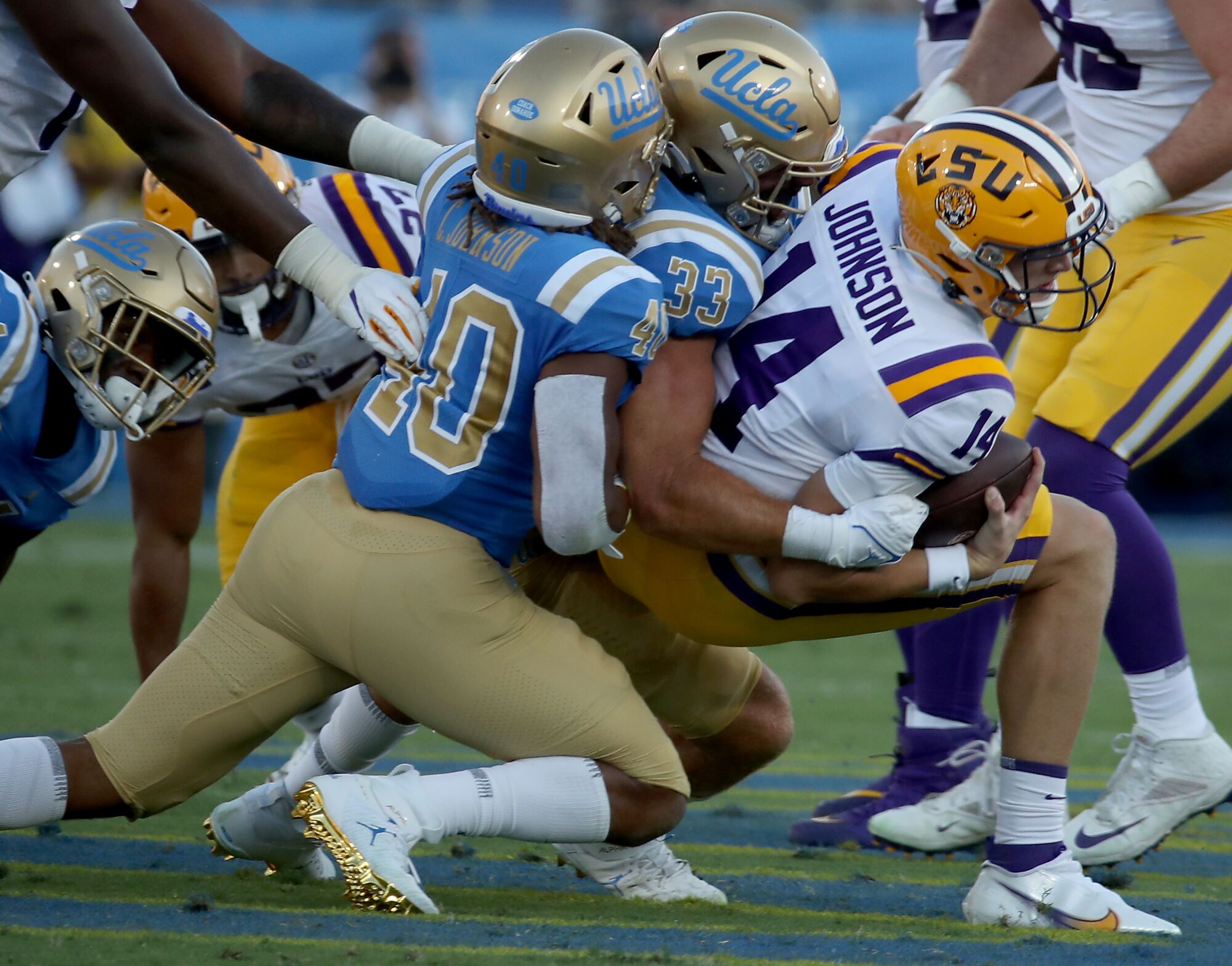 UCLA linebacker Bo Calvert brings LSU quarterback Max Johnson down.