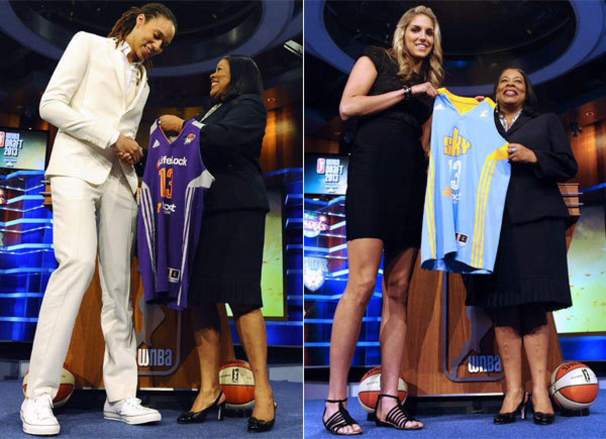 Baylor's Brittney Griner, left, and Delaware's Elena Delle Donne receive their new WNBA jerseys from league president Laurel Richie on Monday night.