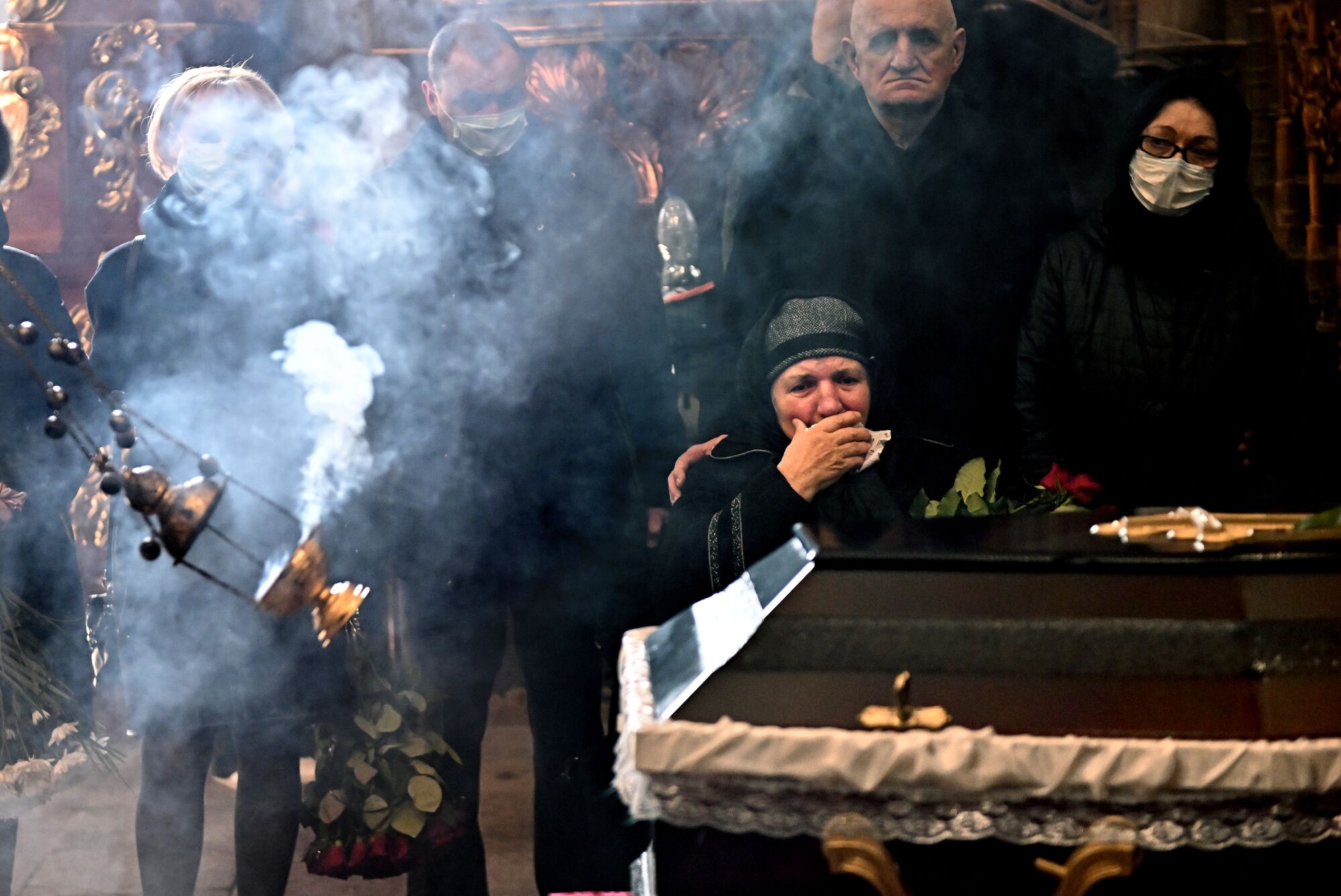 Family members mourn during a funeral service for Ukrainian soldier Ivan Skrypnyk.