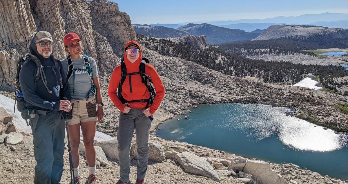 Three people stand above the Cottonwood Lakes Basin.