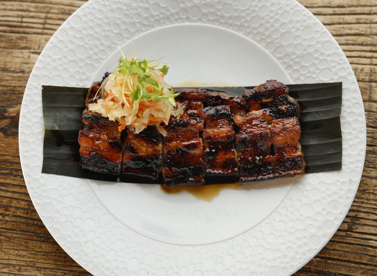 Pork belly liempo (barbecue pork belly) with atchara (pickled green papaya salad)