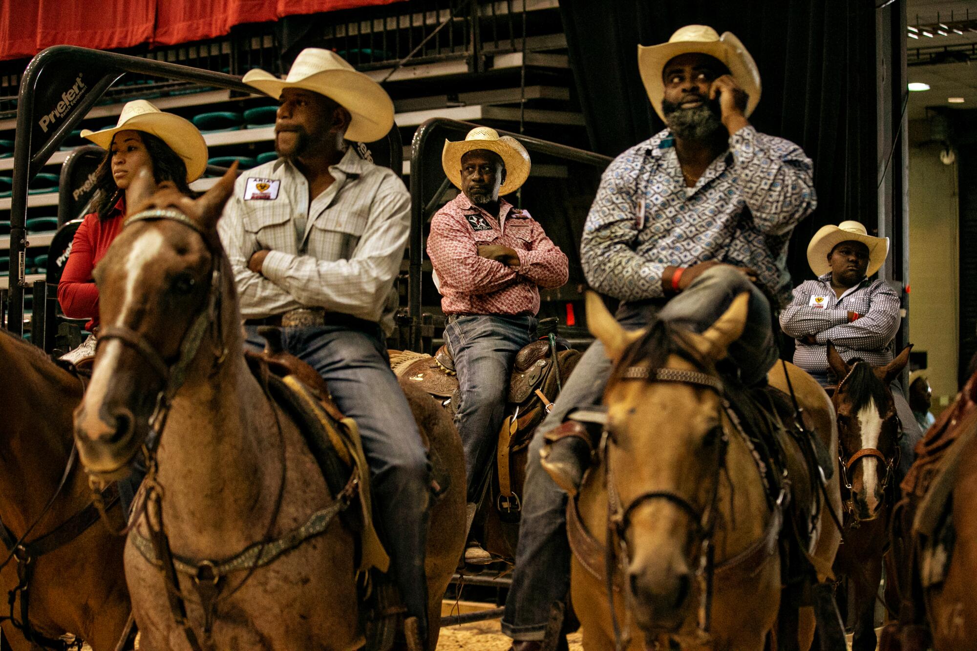 Contestants relax on their horses waiting for the final of the Bill Pickett Invitational Rodeo.