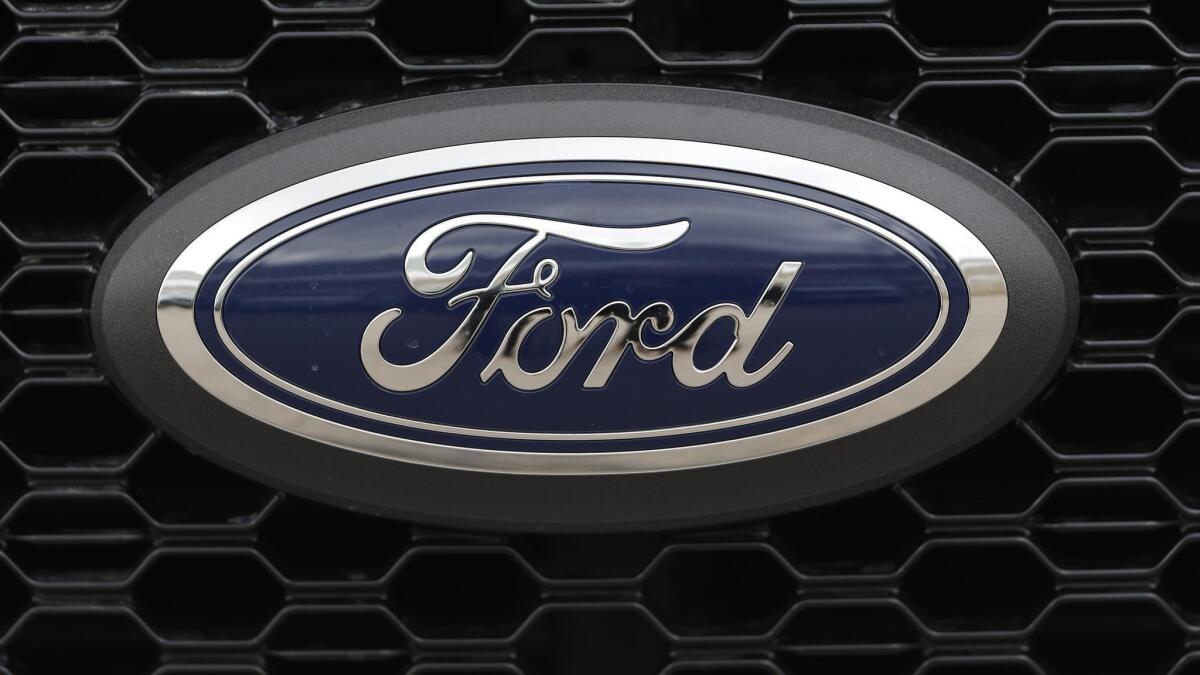The Ford logo on the grille of a 2019 F-150 pickup truck.