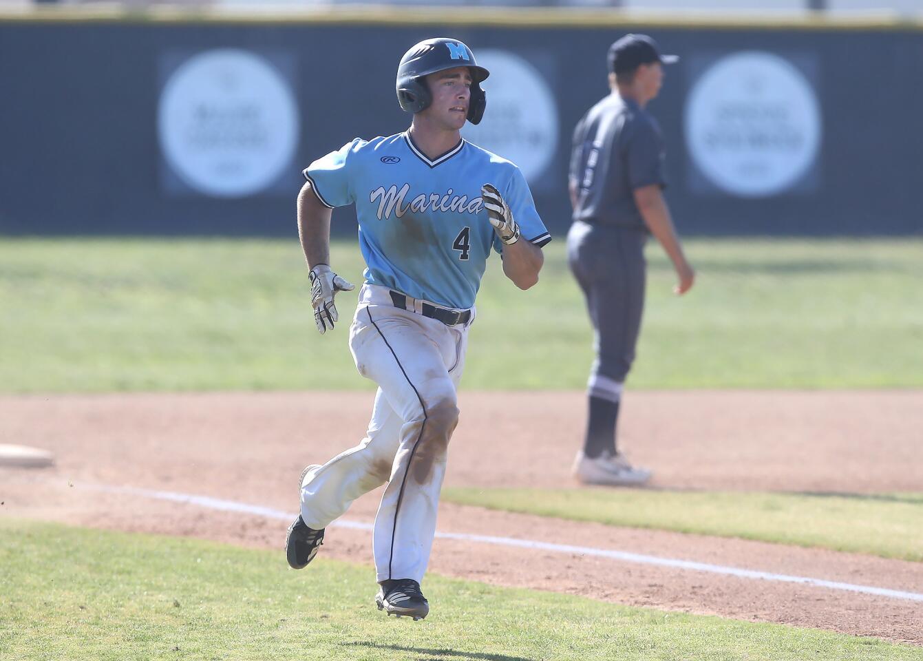 Marina's Dylan Holt runs home to score during a Wave League game against Newport Harbor on Tuesday.