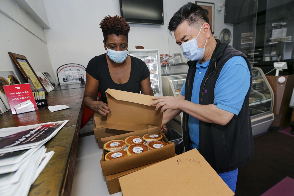 James Chong came from Long Beach to pick up pies from Jeanette Bolden-Pickens at 27th Street Bakery Shop.