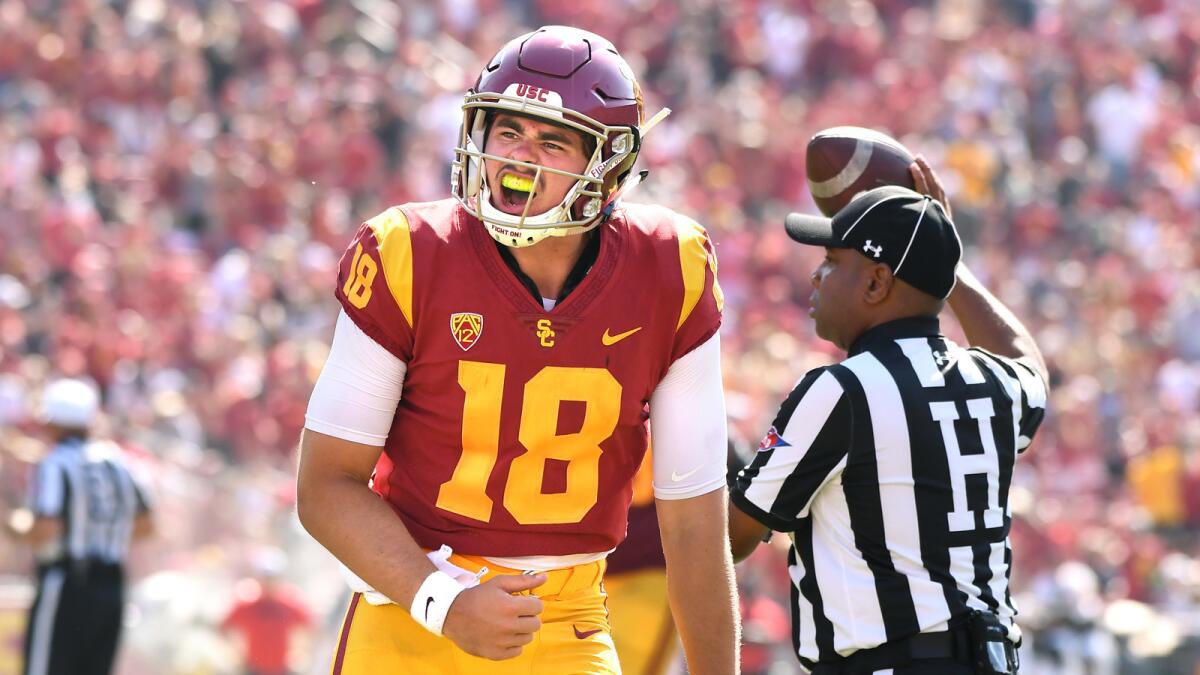 USC quarterback J.T. Daniels celebrates his first touchdown pass against UNLV at the Coliseum.