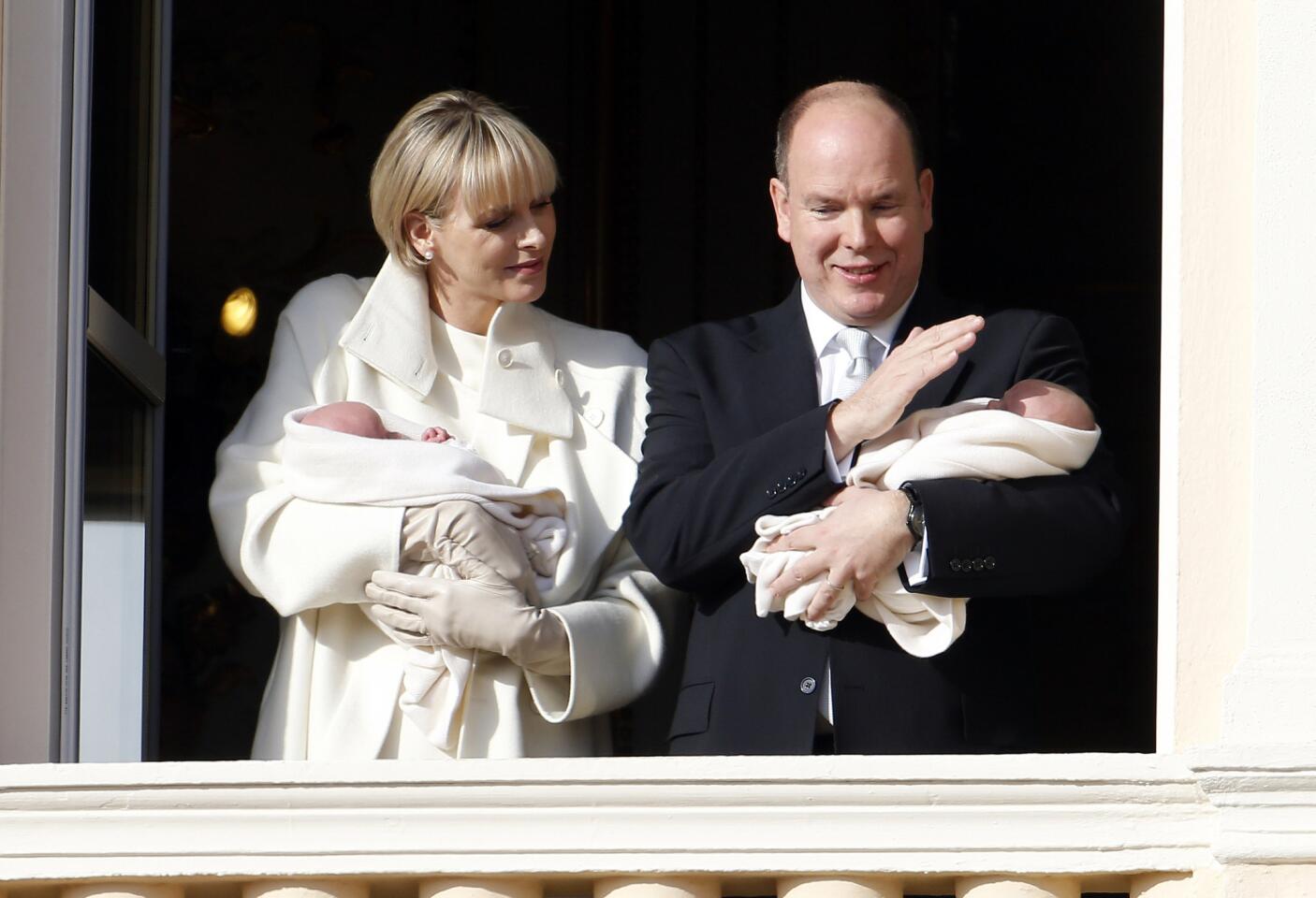 Prince Albert II of Monaco and his wife Princess Charlene appear on the balcony of the Monaco Palace with their newborn twins Prince Jacques and Princess Gabriella on January 7, 2015 in Monaco.