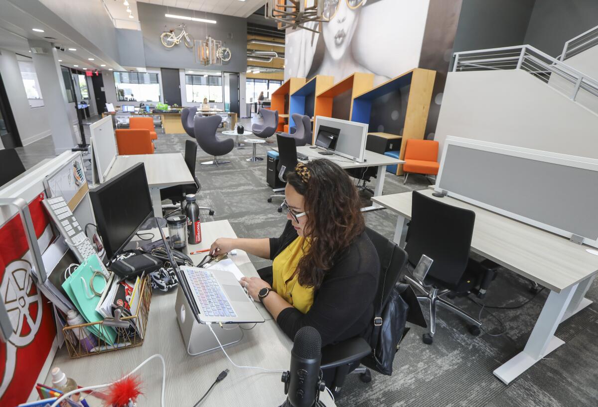 Marketing consultant Marisa Cali sits at her socially-distanced desk at coworking space Downtown Works on May 19, 2020.