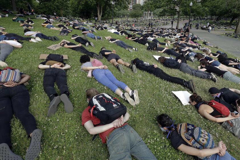 Demonstrators lie face down depicting George Floyd during his detention by police during a protest against police brutality on Boston Common, on Wednesday, June 3, 2020. Floyd, an African American, died on May 25 after a white Minneapolis police officer pressed a knee into his neck for several minutes even after he stopped moving and pleading for air. (AP Photo/Steven Senne)