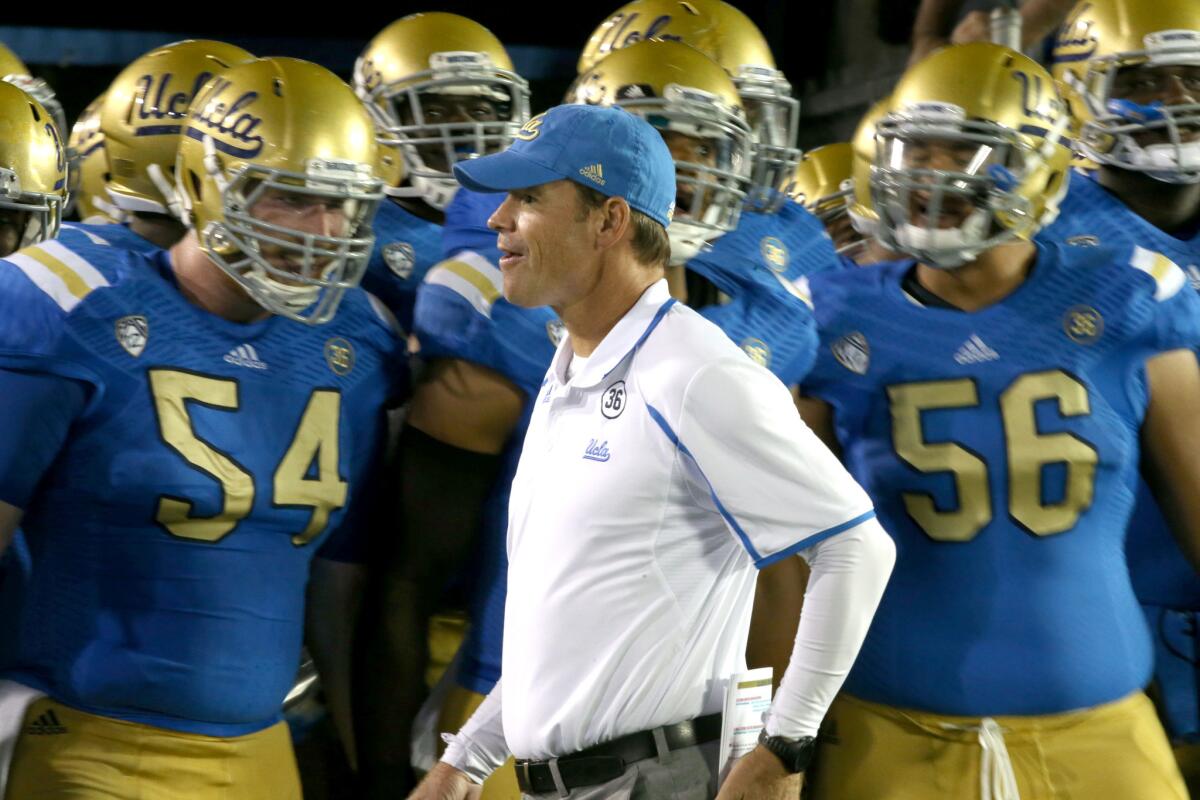 UCLA Coach Jim Mora gets his team fired up before a game on Sept. 21, 2013.
