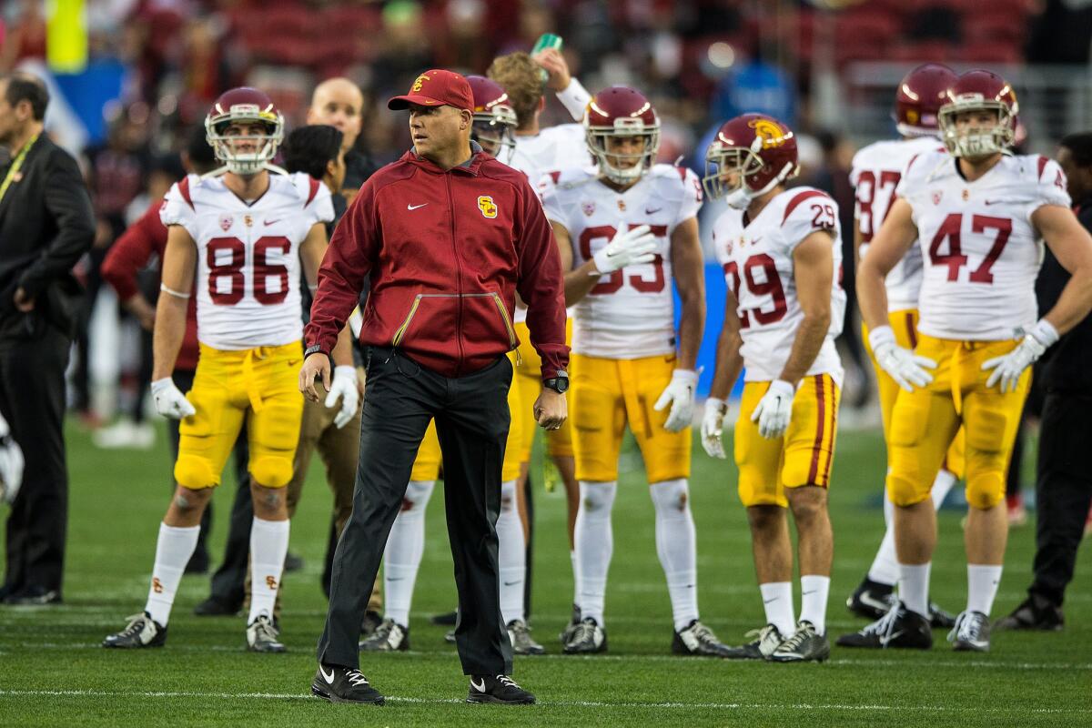 USC Coach Clay Helton watches his team during warmups before the Pac-12 championship game.