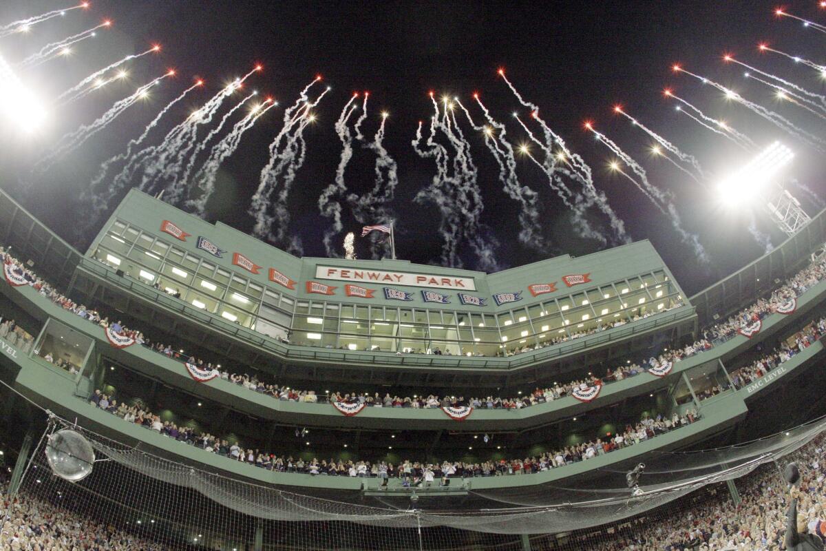 This photo by Associated Press photographer Elise Amendola shows fireworks over the Fenway Park press box 