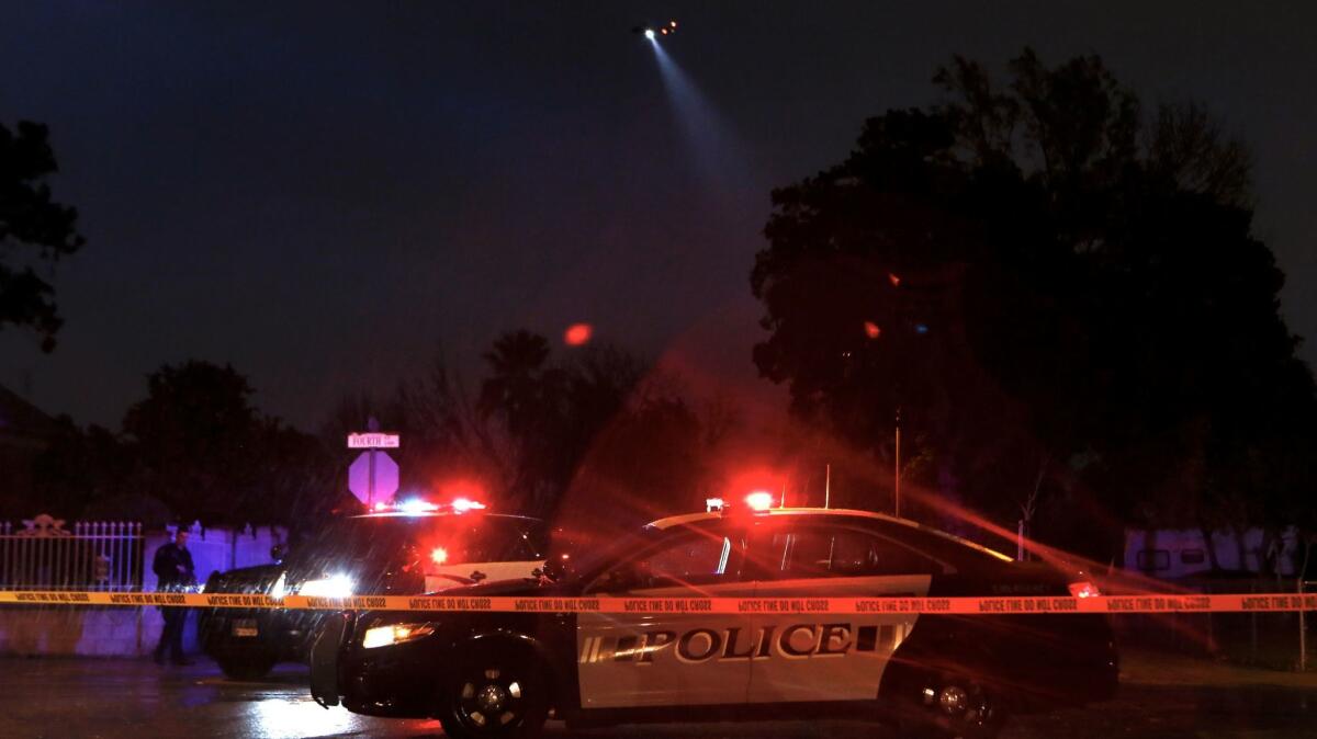 A police helicopter searches for a shooting suspect near the intersection of 4th St. and Harps St. in San Fernando.
