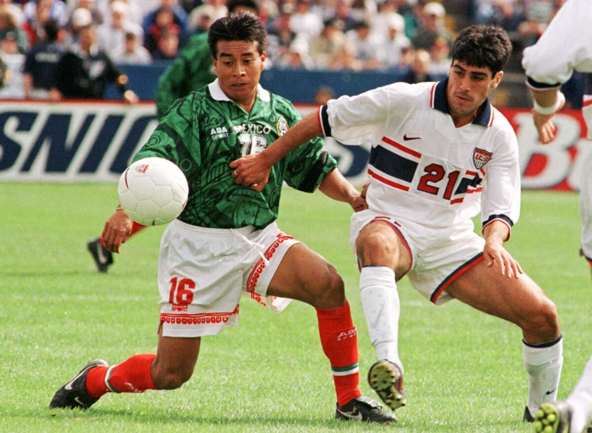 Alberto Coyote (L-16) of the Mexican National Soccer and Claudio Reyna (R-21) of the U.S.A. compete for the ball in first half action of their World Cup Soccer 1998 Final Round Qualifying match April 20 in Foxboro, Massachusetts. The teams finished the match tied 2-2. jrb/Photo by Jim Bourg REUTERS ORG XMIT: FOX04 ORG XMIT: MG9892293225007 ---------- Published: 03/28/2001