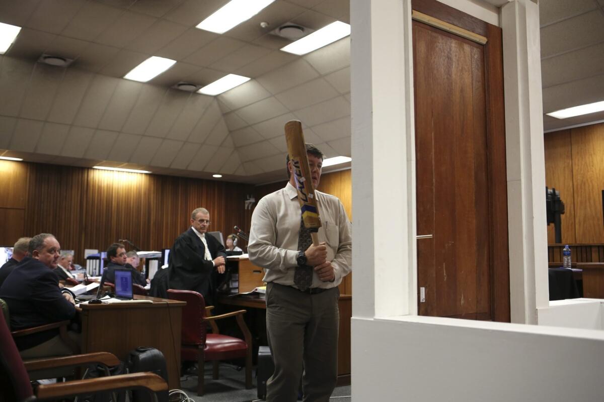Testifying in Oscar Pistorius' murder trial, police forensic expert Lt. Col. Gerhard Vermeulen takes part in a reconstruction of the moments after the Olympic runner shot Reeva Steenkamp.