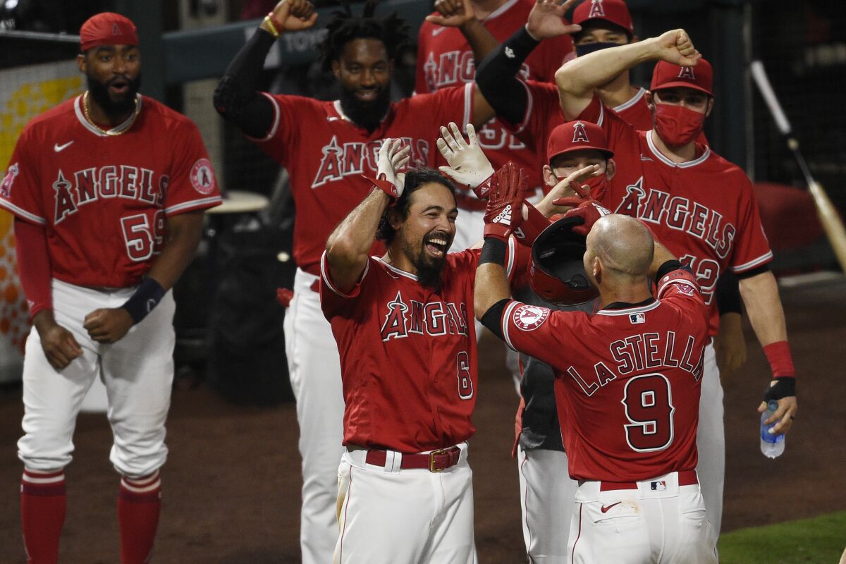Angels' Tommy La Stella, right, celebrates with Anthony Rendon at home plate.