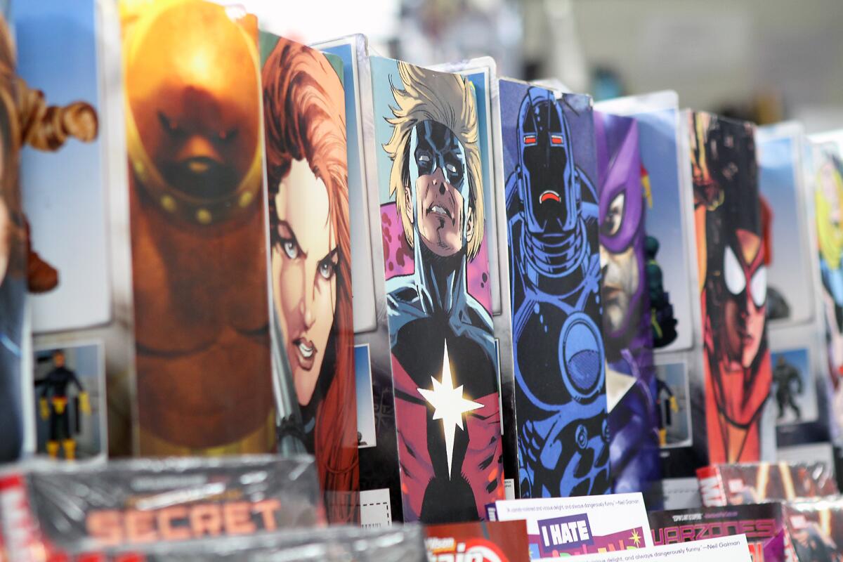 Images of characters from a variety of comic books line the shelves at Legacy Comics and Cards on Wednesday, May 4, 2016.