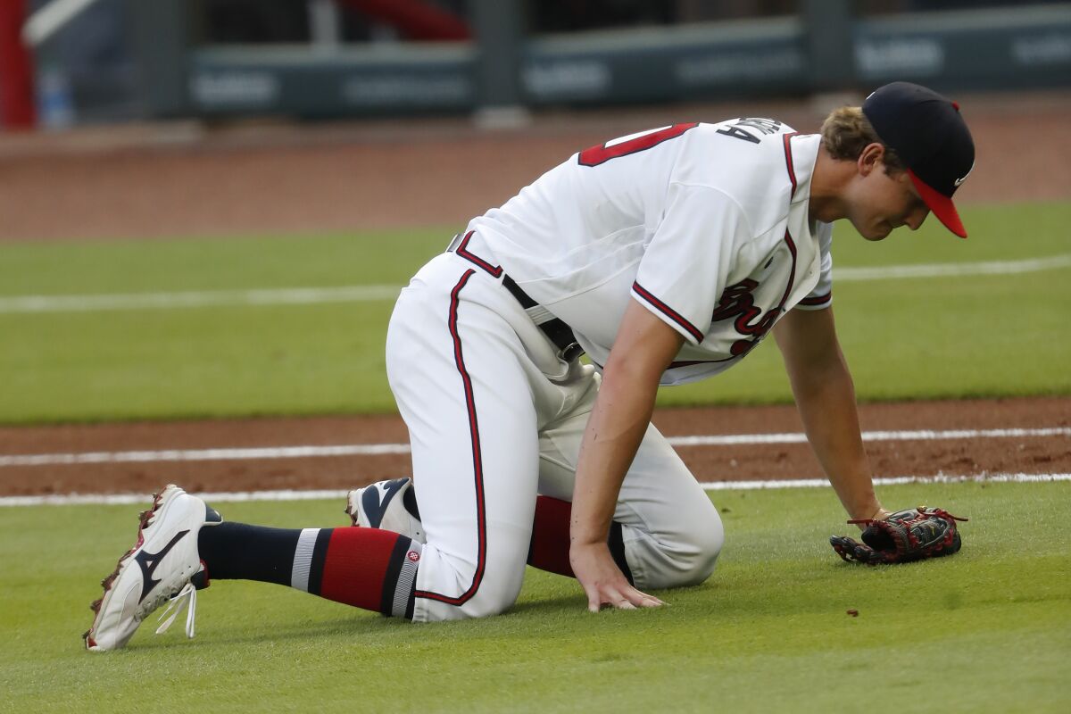 Atlanta Braves starting pitcher Mike Soroka (40) waits for assistance from the training staff after being injured in the third inning of a baseball game against the New York Mets Monday, Aug. 3, 2020, in Atlanta. Soroaka was helped to the dugout and replaced. (AP Photo/John Bazemore)