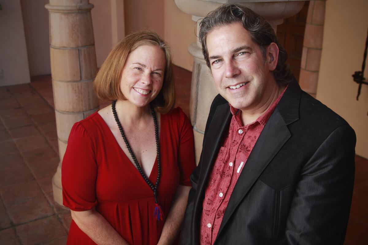 Walter (right) and Diana DuMelle pose for photos at St. James by the Sea