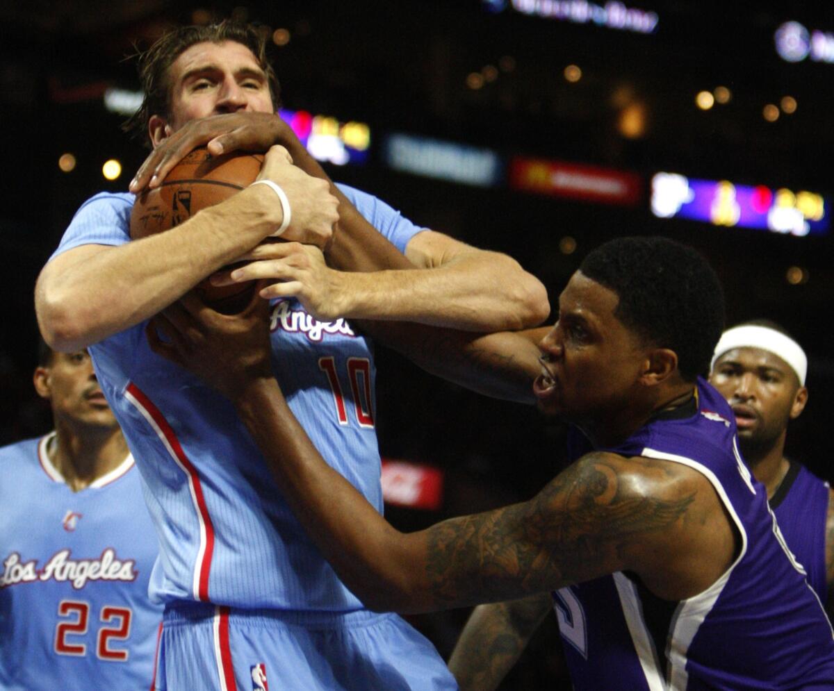 Sacramento Kings forward Rudy Gay, right, tries to pull a rebound away from Clippers forward Spencer Hawes at Staples Center on Sunday.