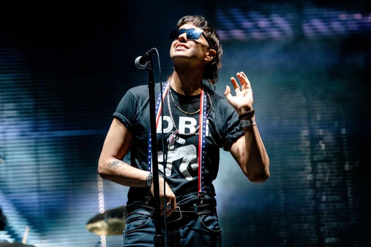 A rock singer in sunglasses onstage.