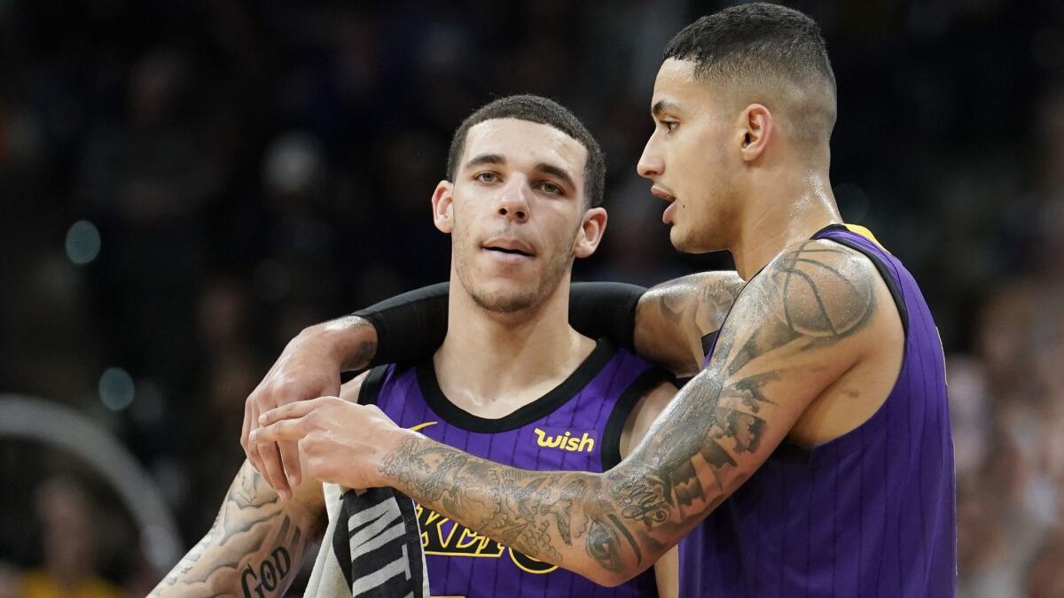 Lakers' Lonzo Ball, left, and Kyle Kuzma talk during a timeout in the second half of a game against the San Antonio Spurs.