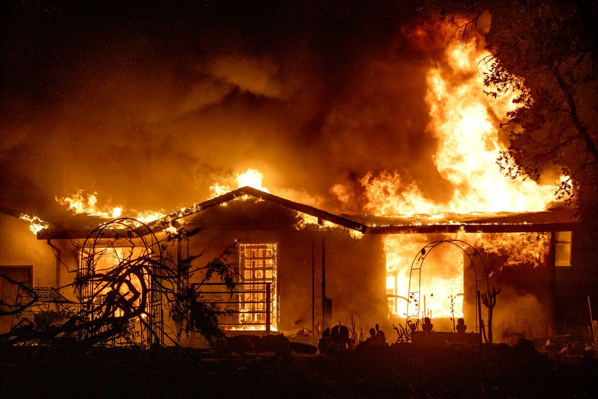 A house burns during the Zogg fire