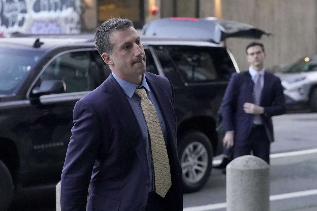 Alex Spiro, left, attorney for Elon Musk, arrives at a federal courthouse.