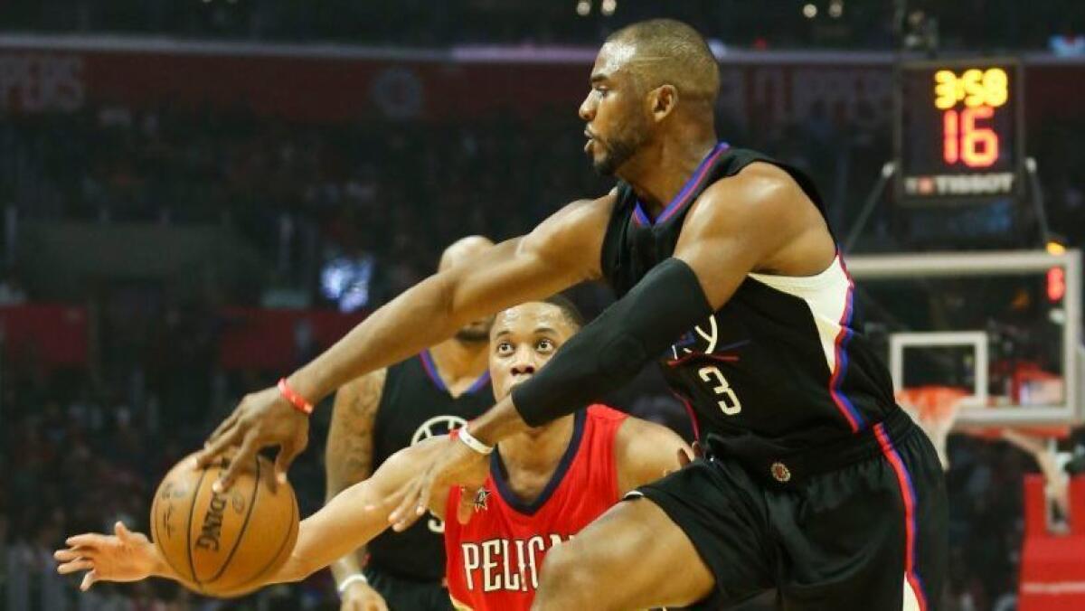 Clippers guard Chris Paul dishes a pass during a game against the Pelicans on Sasturday at Staples Center.