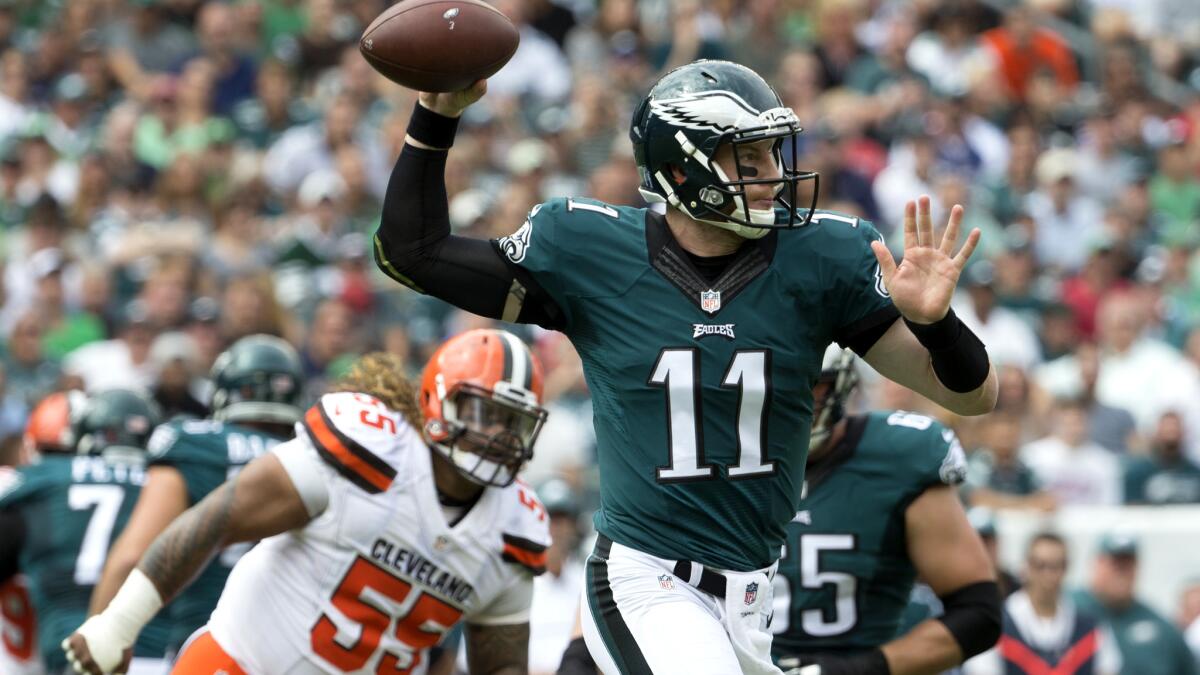Eagles quarterback Carson Wentz prepares to pass while scrambling against the Browns on Sunday.