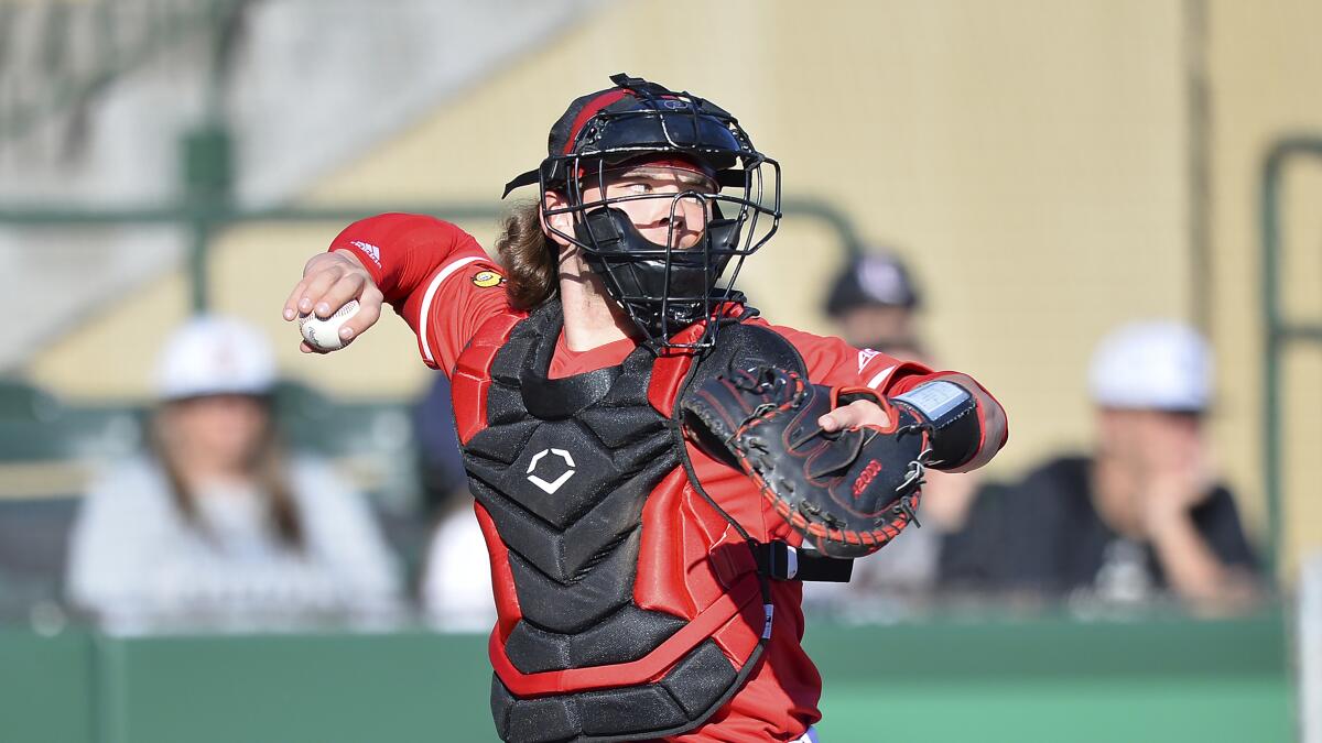 Louisville catcher Dalton Rushing (20) fires down to 2nd during an NCAA baseball game.