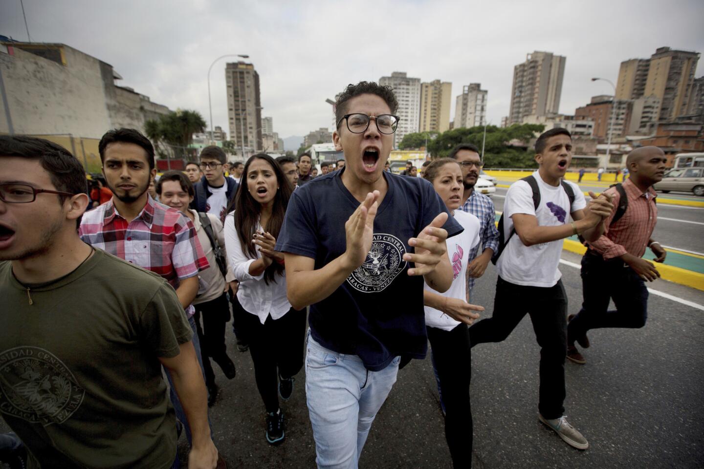 University students shout, "No dictatorship," during a protest outside the Supreme Court in Caracas, Venezuela. Venezuelans have been thrust into a new round of political turbulence after the government-stacked Supreme Court gutted congress of its last vestiges of power, drawing widespread condemnation from foreign governments and sparking protests in the capital.