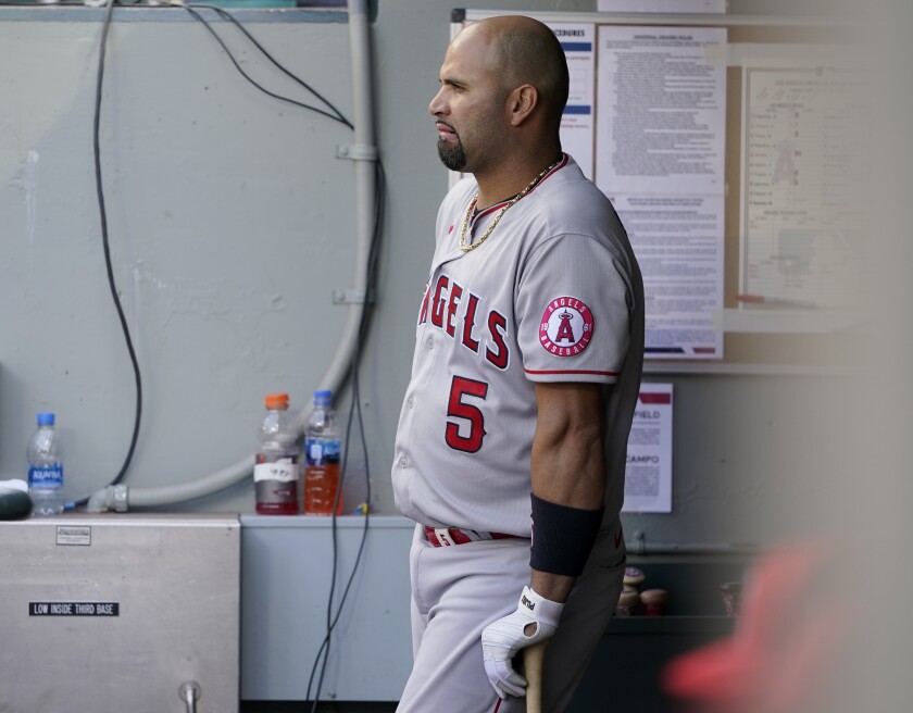 Los Angeles Angels Albert Pujols leans on his bat in the dugout during the eighth inning of a baseball game against the Seattle Mariners, Sunday, May 2, 2021, in Seattle. (AP Photo/Ted S. Warren)