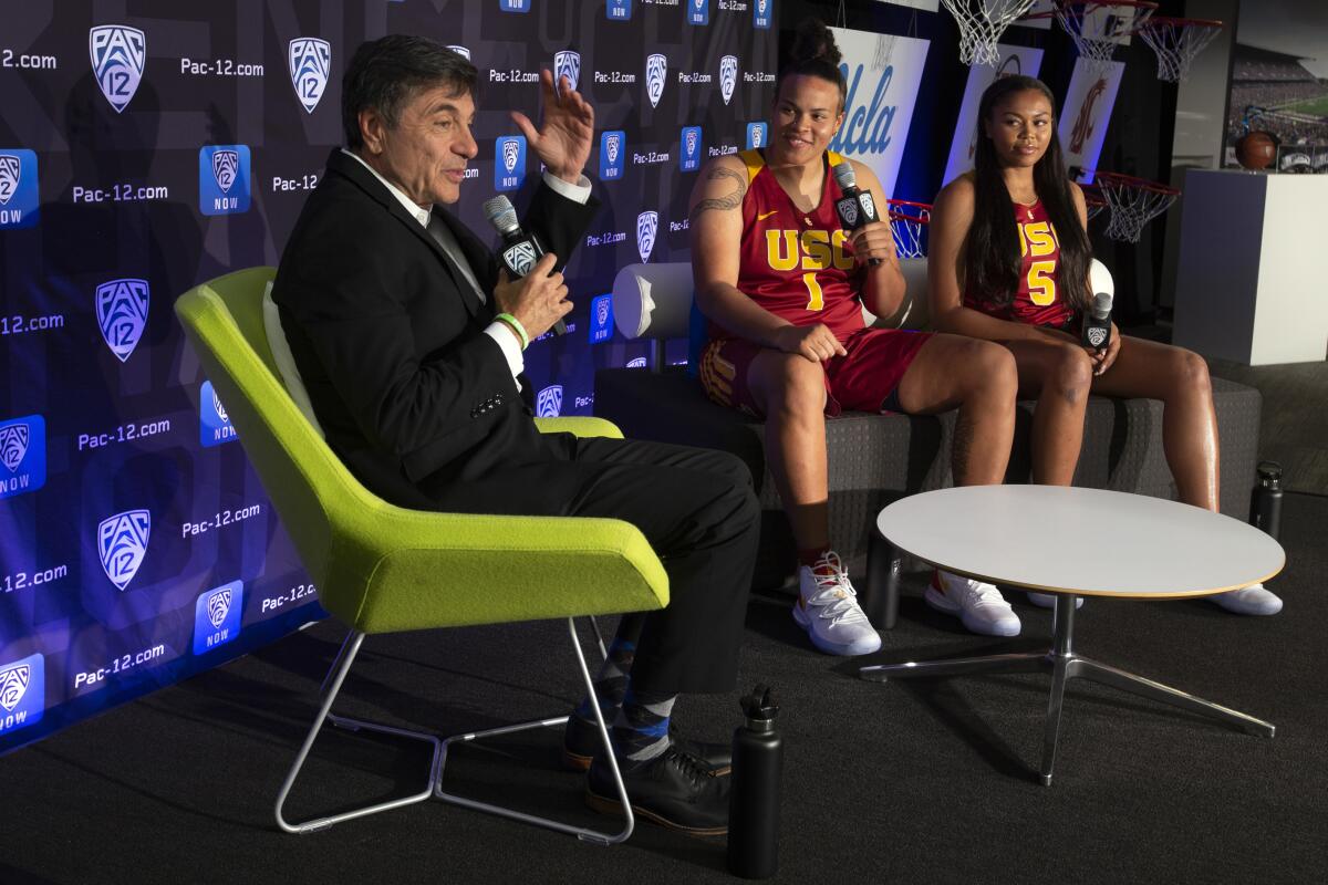 USC coach Mark Trakh and players Kayla Overbeck, center, and Stephanie Watts, speak during the Pac-12 Conference media day Oct. 7 in San Francisco.