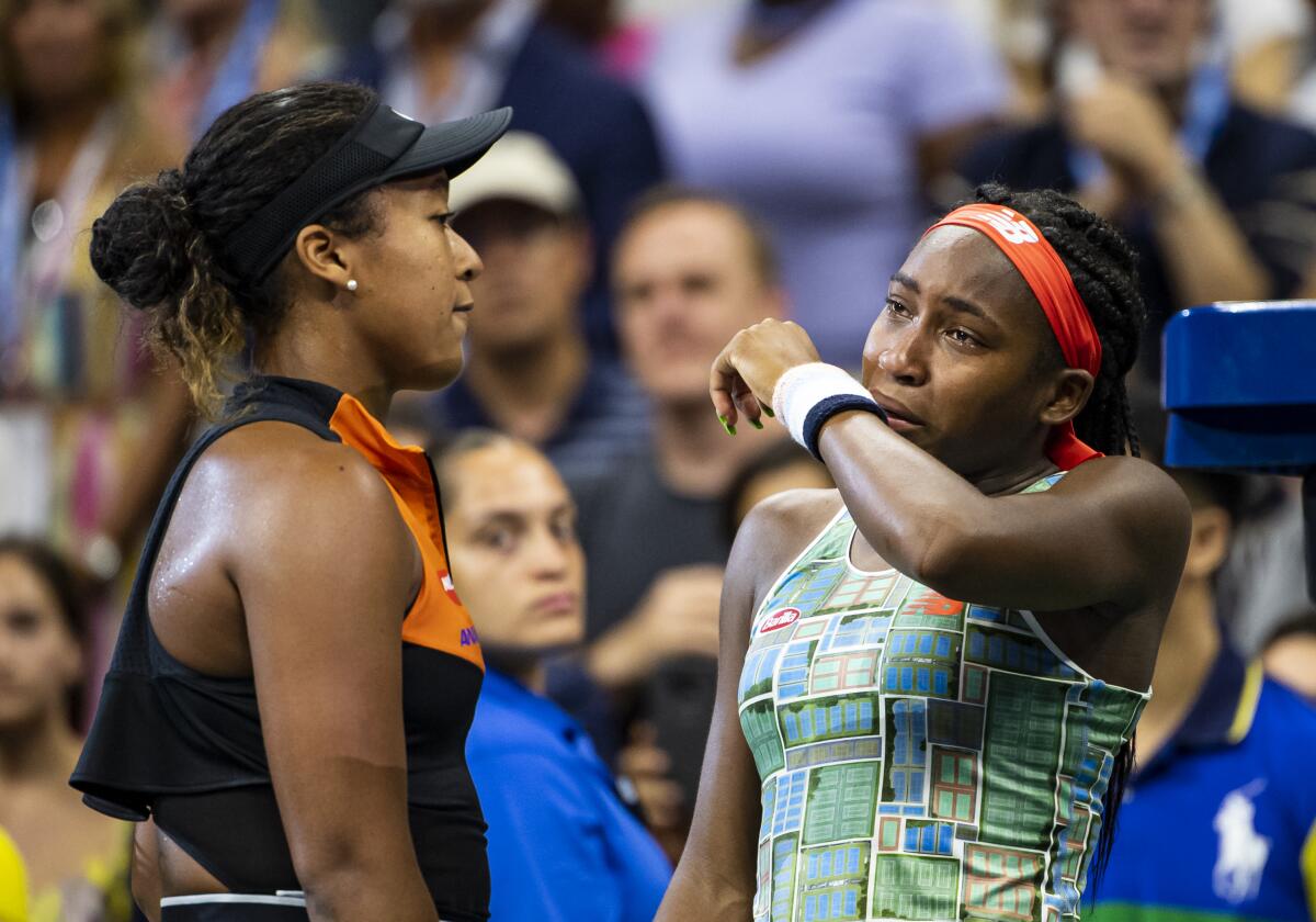 A tearful Coco Gauff, right, is consoled by Naomi Osaka after Osaka's 6-3, 6-0 victory Aug. 31.