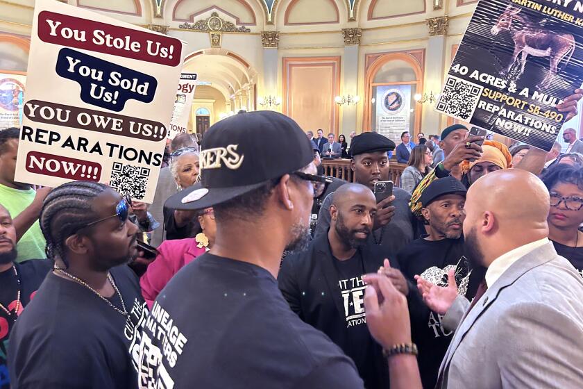 Advocates for reparations talk to Assemblymember Isaac Bryan at the state Capitol in Sacramento on August 31, 2024. Laurel Rosenhall / Los Angeles Times