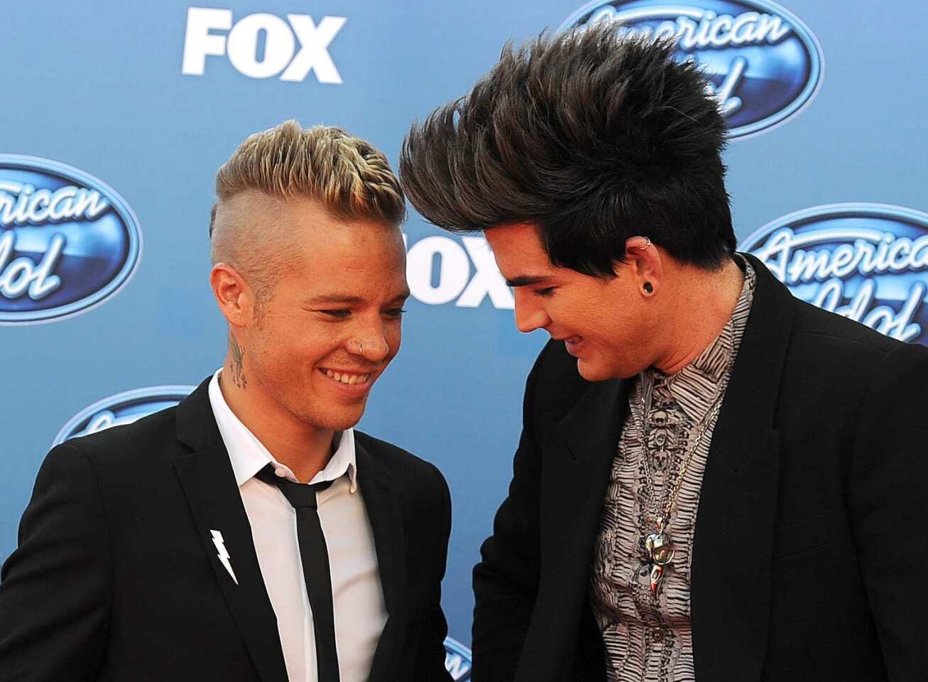 A fight between "American Idol" runner-up Adam Lambert and boyfriend Sauli Koskinen came to fisticuffs Wednesday night when the pair got into a brawl outside a club in Helsinki. They were hauled off to separate jails and spent the night in the pen before being released. The pair quickly put the incident behind them and even laughed about it over burgers according to Lambert's Twitter feed, "Jetlag+Vodka=blackout. Us÷blackout=irrational confusion. jail+guilt+press=lesson learned. Sauli+Adam+hangover burgers= laughing bout it."