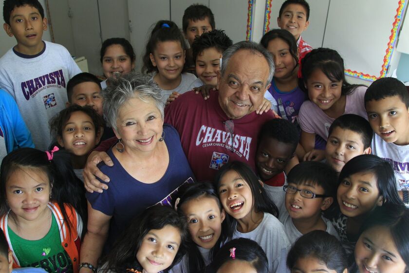Linda and Carlos LeGerrette (center) get a group hug from students in the Cesar Chavez Service Club at San Diego’s Central Elementary.