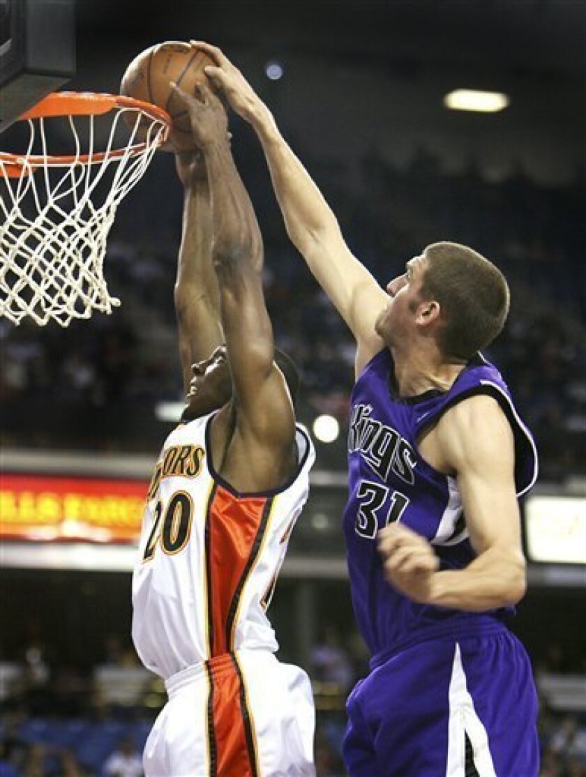Sacramento Kings center Spencer Hawes (31) blocks a shot by Golden State Warriors guard DeMarcus Nelson (20) during the first half of an NBA basketball game in Sacramento, Calif., Sunday, Nov. 9, 2008. (AP Photo/Steve Yeater)