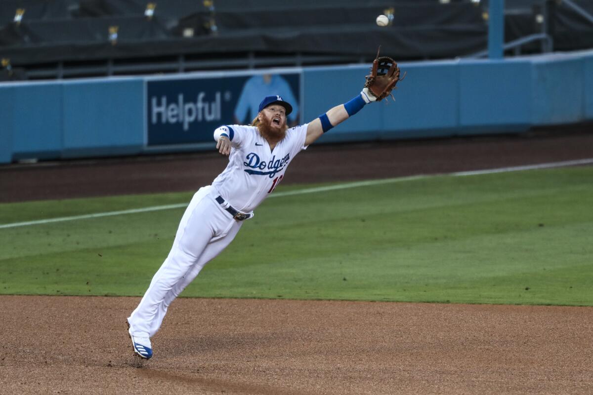 Dodgers third baseman Justin Turner can't haul in a liner hit by Giants first baseman Darin Ruf.