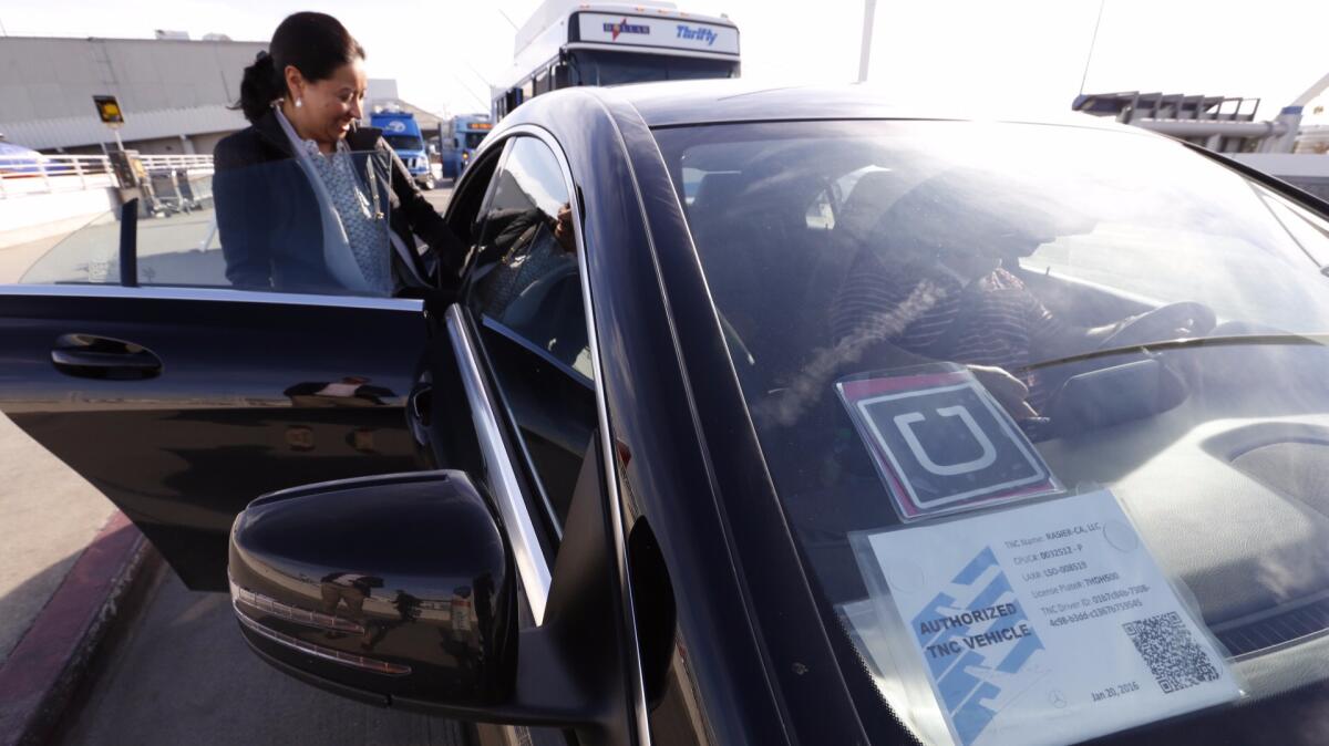 Ann Marie Bingo catches an UberX ride at Los Angeles International Airport in January. Uber and Lyft are being used almost as much as taxis and rental cars by U.S. business travelers, a new study shows.
