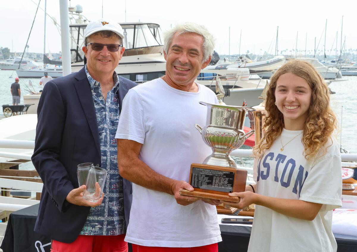 Rod Turner, middle, and his daughter, Ashley, with the perpetual trophy.