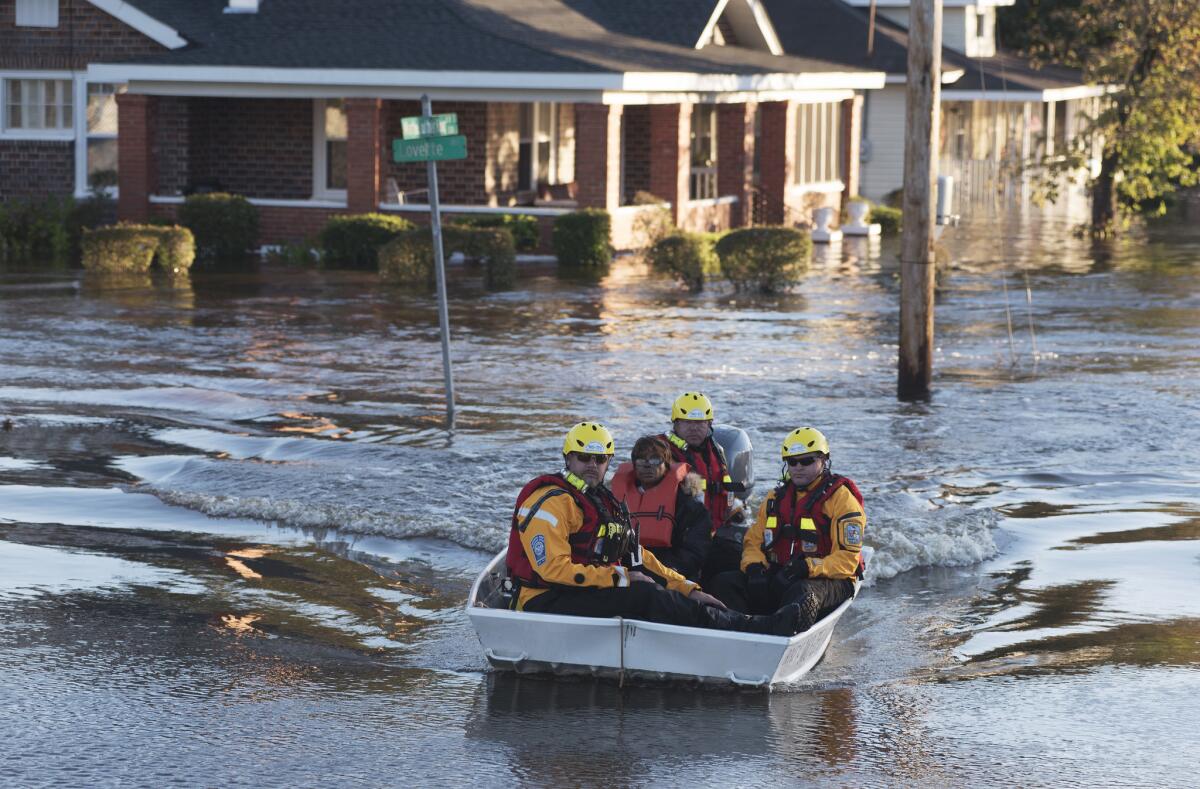 A rescue team transports a resident to safety in Lumberton, N.C.